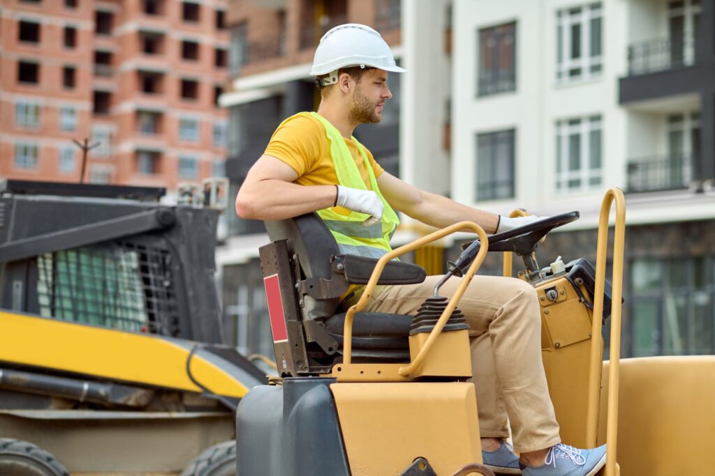 Profile of man sitting at wheel of excavator