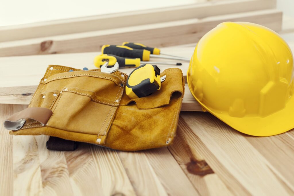 Wooden table with work tools and helmet